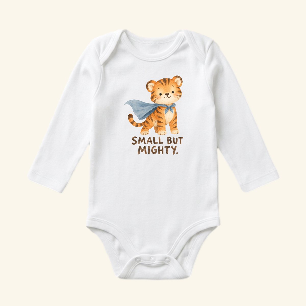 Small But Mighty Baby Onesie – Superhero Tiger Bodysuit, a white long-sleeve baby bodysuit featuring an illustration of a superhero tiger wearing a blue cape with the text SMALL BUT MIGHTY.