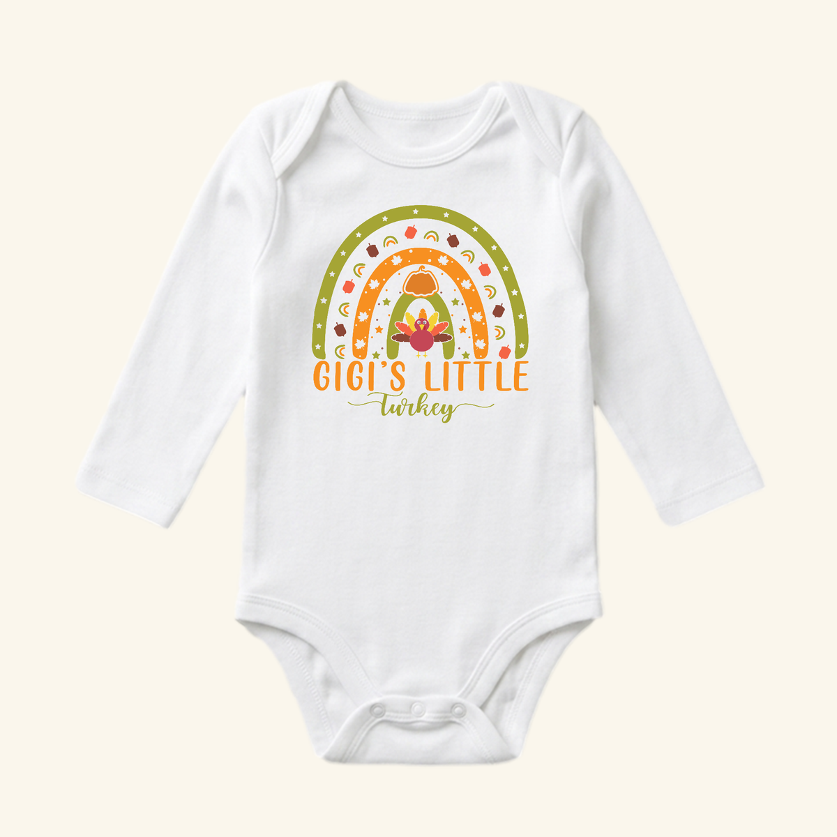 White long-sleeve Gigi’s Little Turkey Baby Onesie – Grandma Thanksgiving Rainbow Bodysuit featuring a rainbow graphic with a turkey, pumpkin, and autumn leaves.