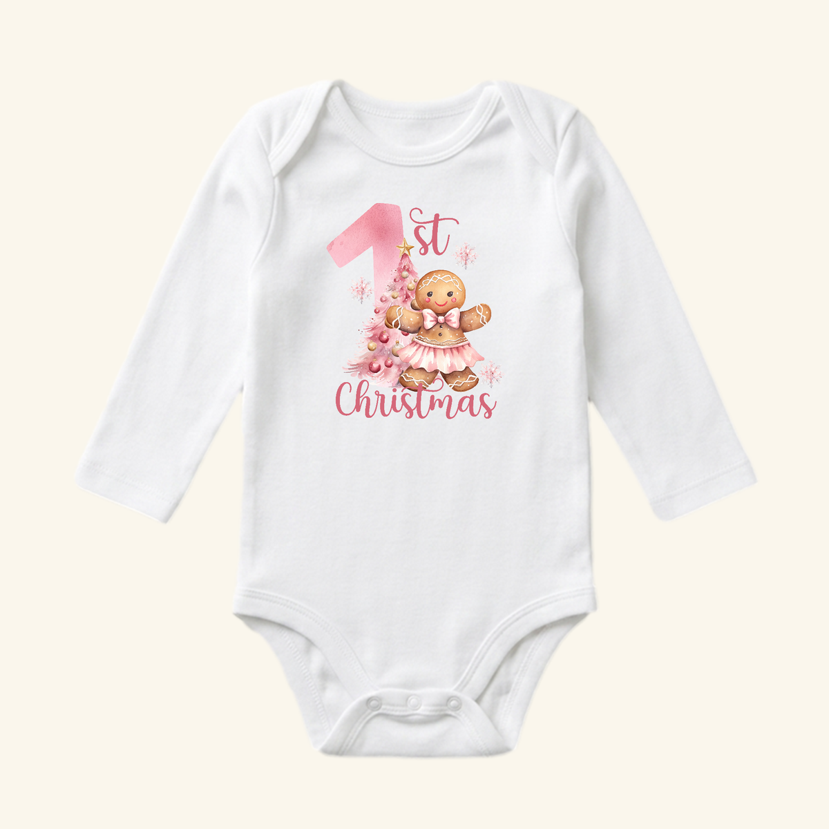 Toodleroos Baby Girl First Christmas Onesie – Gingerbread Holiday Bodysuit featuring a white long-sleeve design with a graphic of a gingerbread girl in a tutu next to a pink Christmas tree and the text 1st Christmas.
