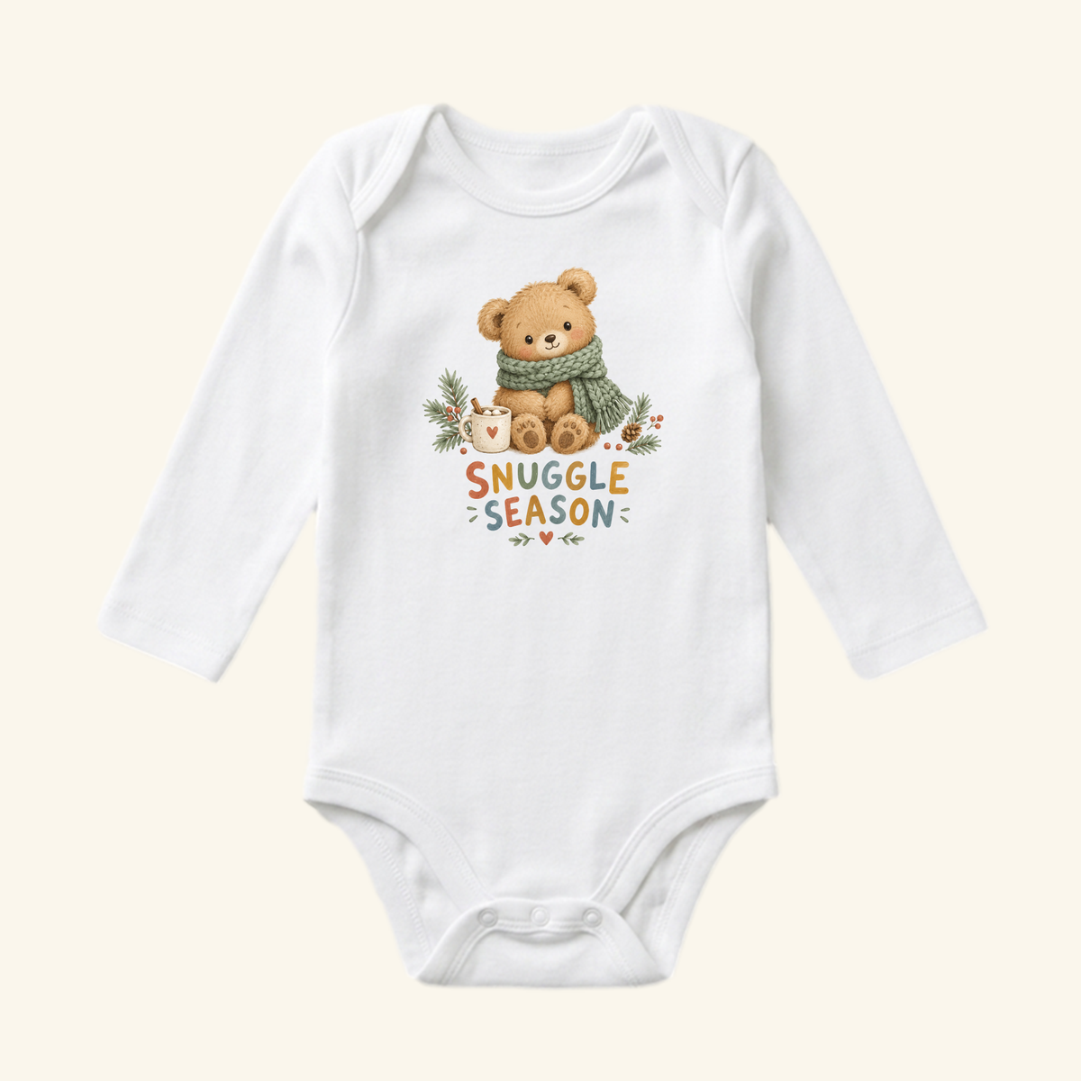 Snuggle Season Baby Onesie – Cozy Winter Teddy Bear Bodysuit, a white long-sleeved baby bodysuit featuring a teddy bear wearing a scarf next to a mug, with SNUGGLE SEASON text underneath.