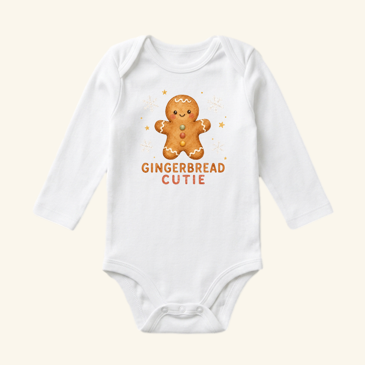 Toodleroos Gingerbread Cutie Baby Onesie featuring a white long-sleeve design with a graphic of a gingerbread man surrounded by snowflakes and the text GINGERBREAD CUTIE.