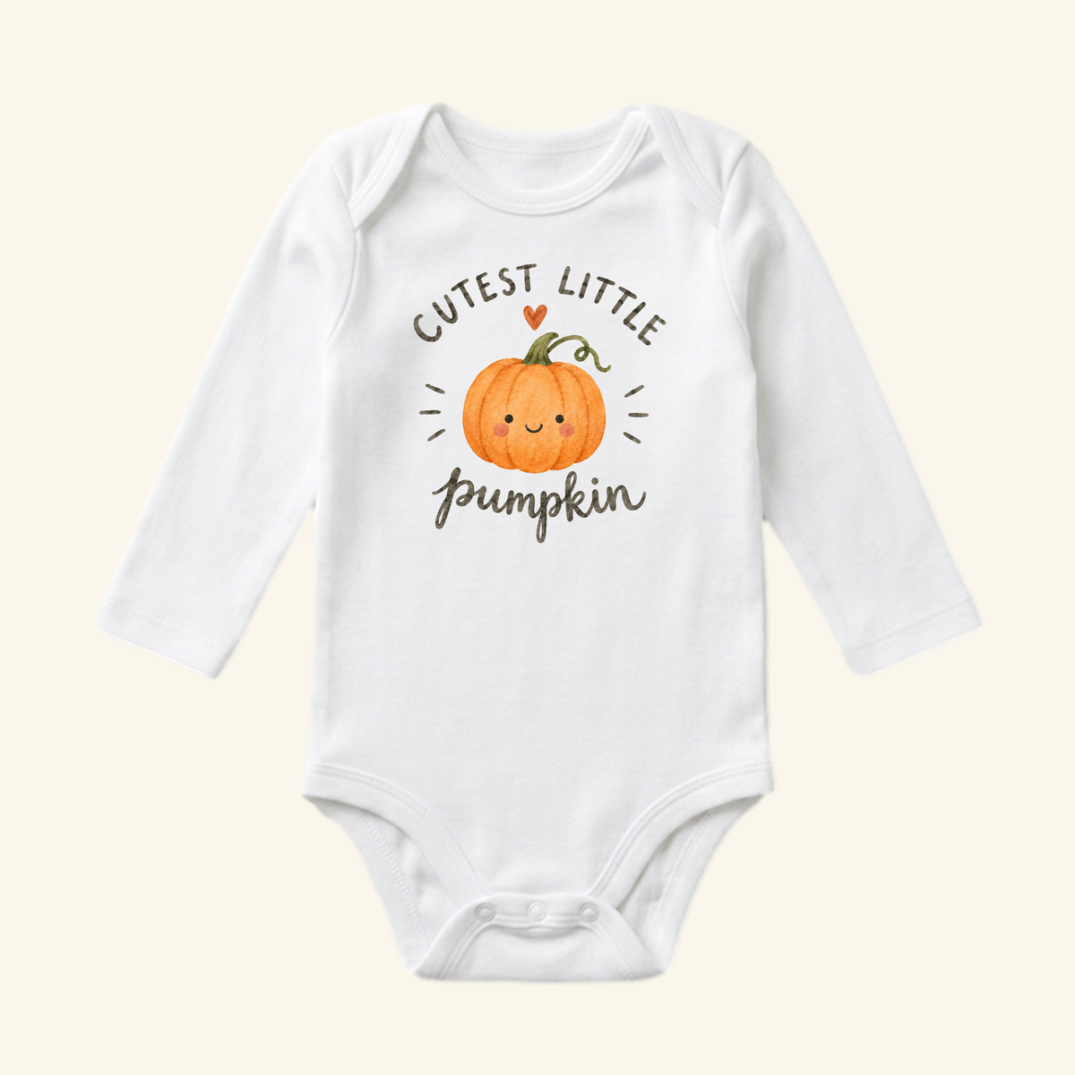 Toodleroos Cutest Little Pumpkin Baby Onesie featuring a white long-sleeved bodysuit with a smiling pumpkin illustration, a small heart, and the text CUTEST LITTLE pumpkin.