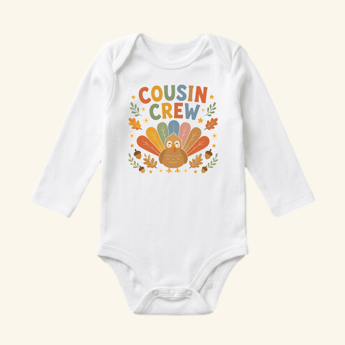 Toodleroos Thanksgiving Baby Onesie – Cousin Crew Turkey Bodysuit, a white long-sleeve onesie featuring a turkey graphic and the text COUSIN CREW surrounded by autumn leaves and acorns.