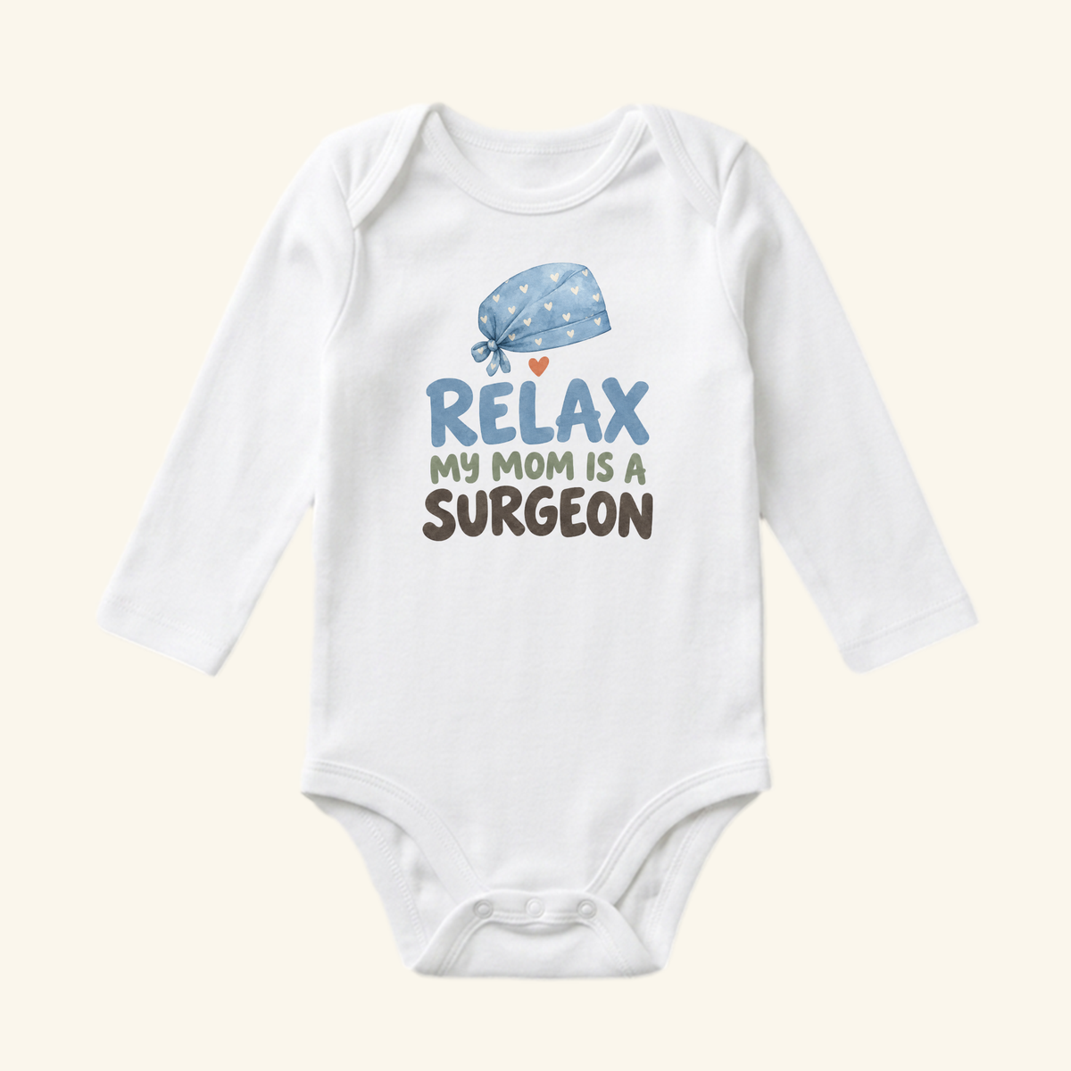 White long-sleeve Surgeon Mom Baby Onesie – Relax My Mom Is a Surgeon bodysuit featuring a blue surgical cap illustration and the text Relax my mom is a surgeon.