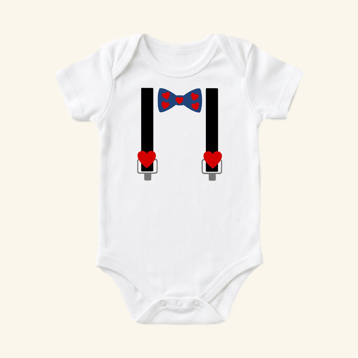 Toodleroos Valentine’s Day Baby Onesie – Heart Bow Tie & Suspenders Bodysuit featuring a white bodysuit, a blue heart bow tie, and black suspenders with red heart accents.