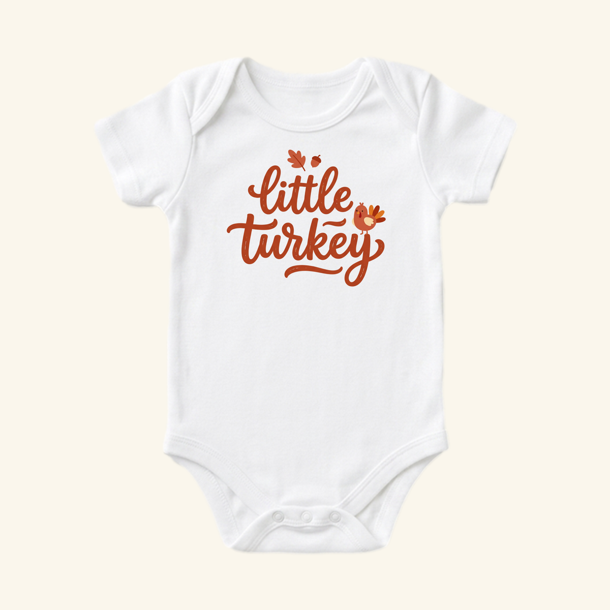 Little Turkey Baby Onesie – Hand-Lettered Thanksgiving Bodysuit featuring the text little turkey in brown hand-lettered font, accented with a small cartoon turkey, acorn, and leaf on a white baby bodysuit.
