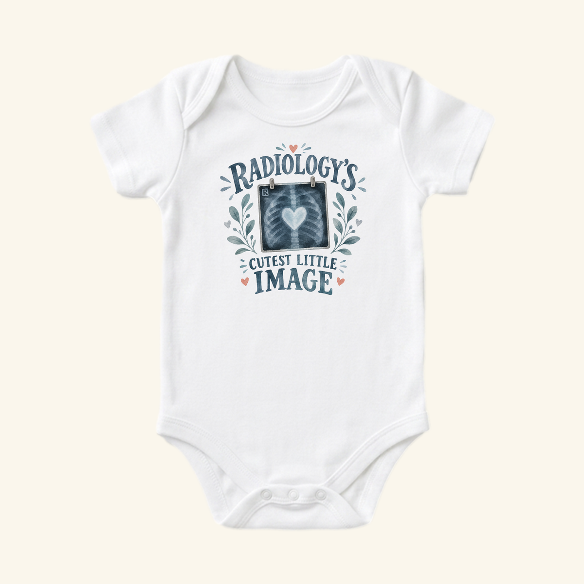 White Radiology’s Cutest Little Image Baby Onesie – Rad Tech Bodysuit featuring an X-ray graphic with a central heart, botanical illustrations, and the text Radiologys Cutest Little Image.