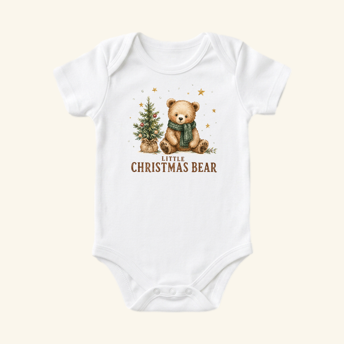Little Christmas Bear Baby Onesie featuring a white bodysuit with a teddy bear in a green scarf sitting next to a decorated Christmas tree and the text Little Christmas Bear below.