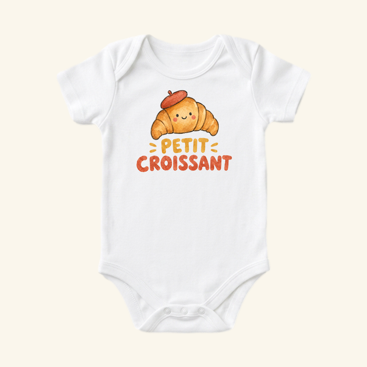 Petit Croissant Baby Onesie – Cute French Croissant Bodysuit featuring a white bodysuit with a watercolor illustration of a croissant wearing a red beret and the text Petit Croissant underneath.