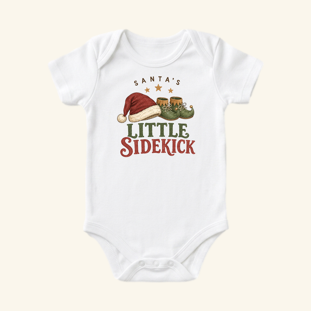 Toodleroos Santa’s Little Sidekick Baby Onesie – Christmas Elf Bodysuit, a white baby bodysuit featuring a graphic of a Santa hat and elf shoes with the text Santa’s Little Sidekick.