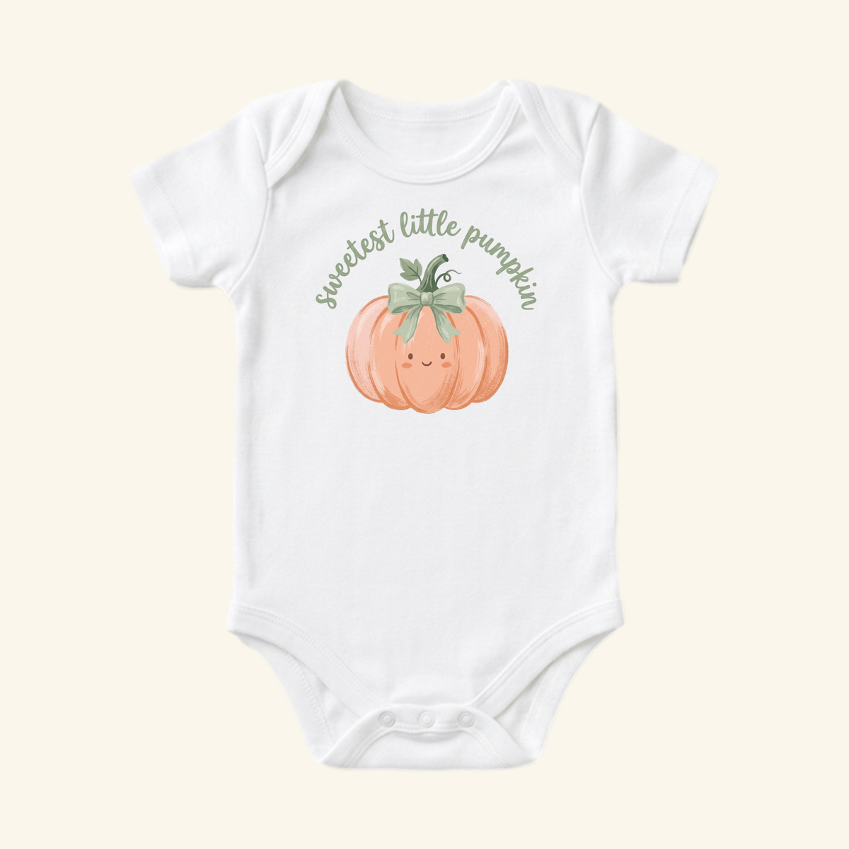 Toodleroos Sweetest Little Pumpkin Baby Onesie – Fall Pumpkin Bow Bodysuit, a white short-sleeved bodysuit with a peach-colored pumpkin, a green bow, and the text sweetest little pumpkin printed on the chest.