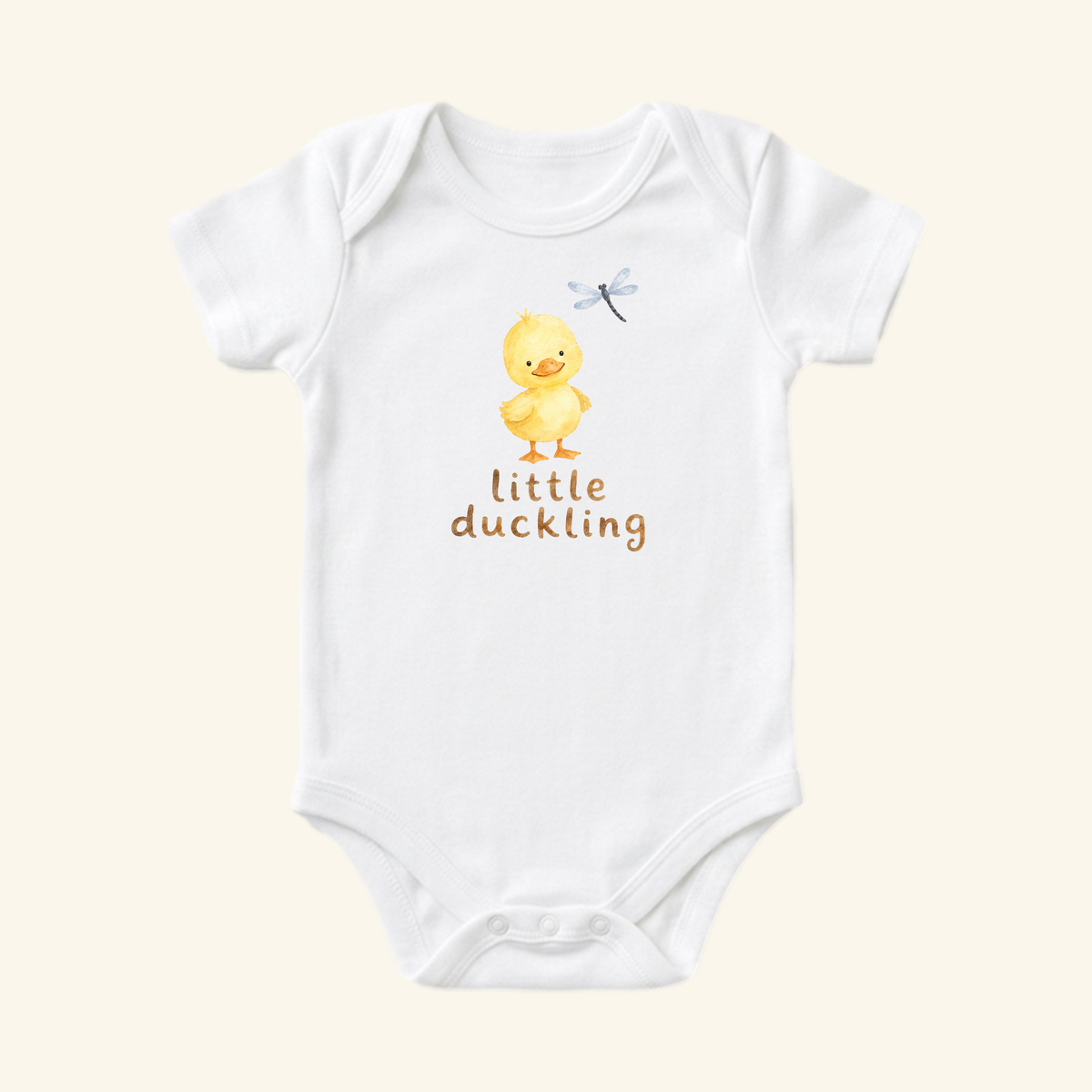 Little Duckling Baby Onesie featuring a white short-sleeved bodysuit with a watercolor duckling and dragonfly illustration and the text little duckling printed below.