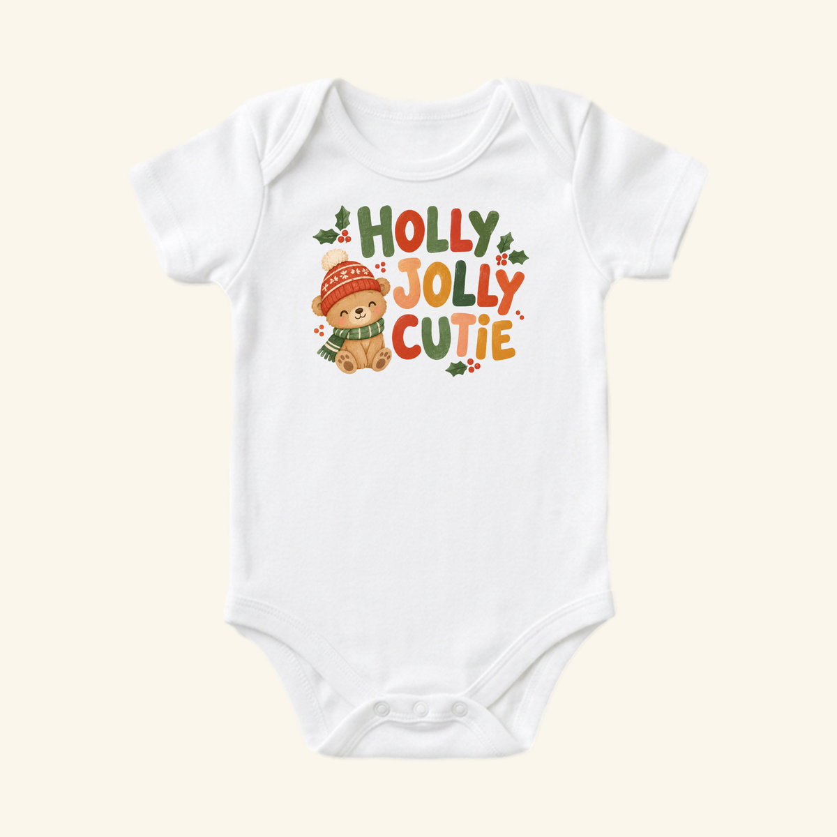 Toodleroos Holly Jolly Cutie Baby Onesie featuring a white bodysuit with a teddy bear in a hat and scarf surrounded by holly and the text HOLLY JOLLY CUTIE.