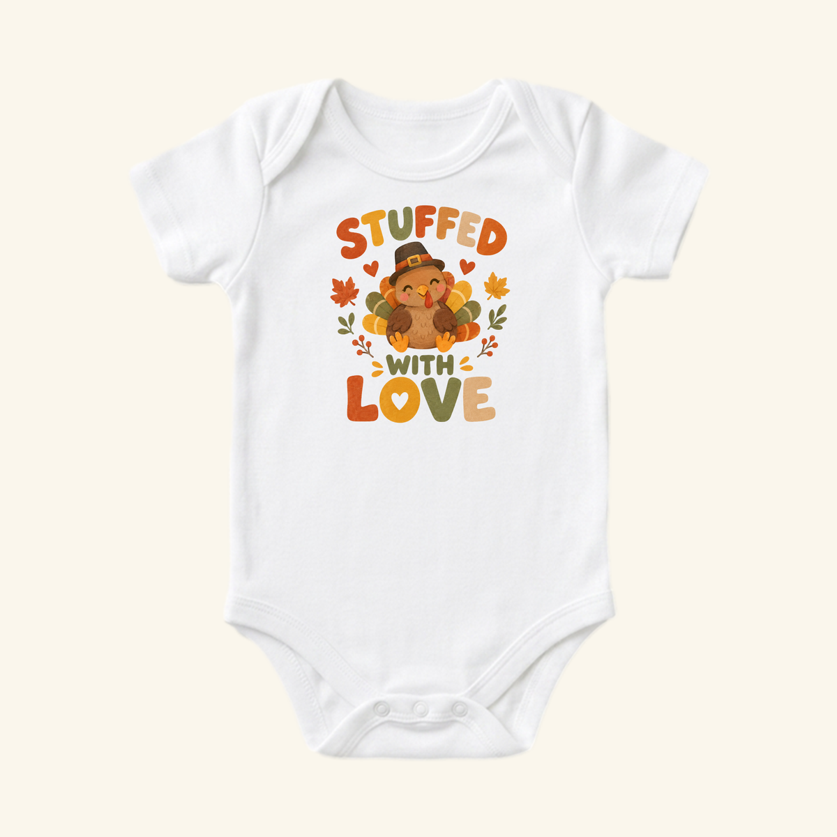 Toodleroos Stuffed With Love Baby Onesie – Thanksgiving Turkey Bodysuit featuring a turkey in a pilgrim hat surrounded by autumn leaves and the text STUFFED WITH LOVE.