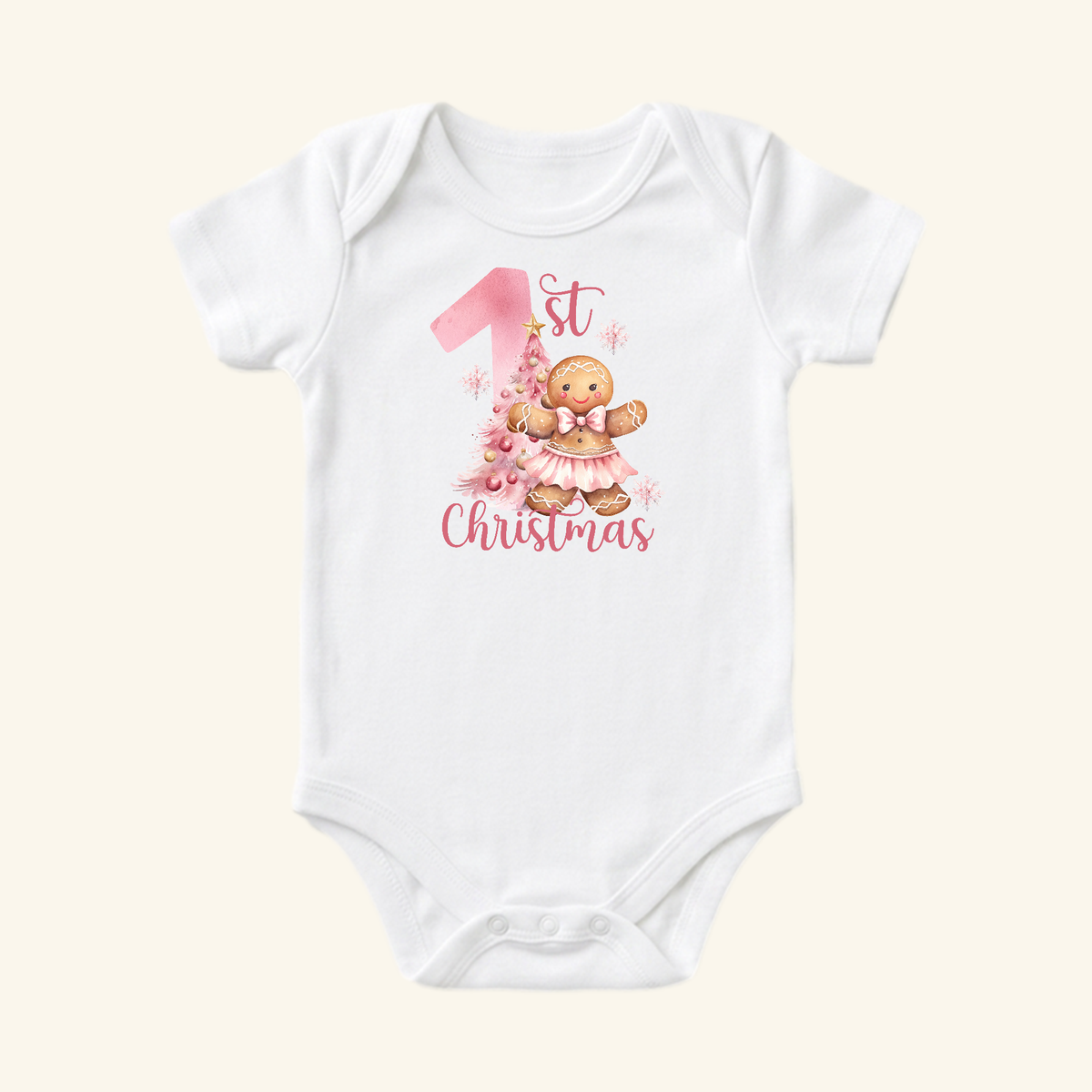 Baby Girl First Christmas Onesie – Gingerbread Holiday Bodysuit, a white short-sleeved bodysuit featuring a gingerbread girl in a pink tutu, a pink Christmas tree, and 1st Christmas text.
