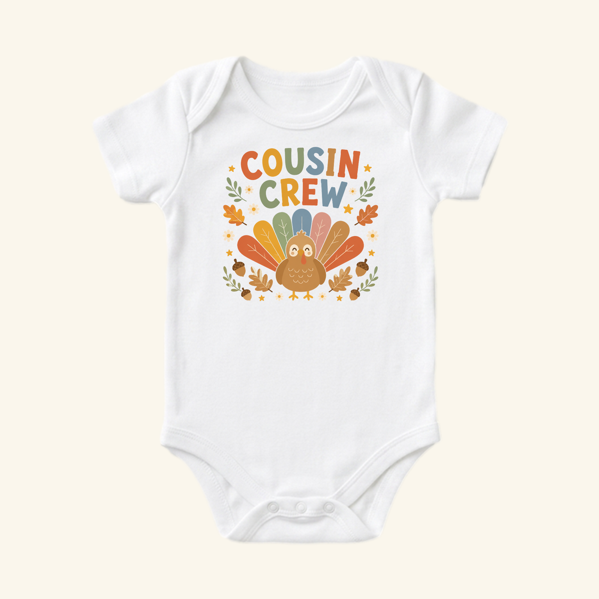 Toodleroos Thanksgiving Baby Onesie – Cousin Crew Turkey Bodysuit featuring a turkey graphic and the text COUSIN CREW surrounded by colorful fall leaves and acorns on a white background.