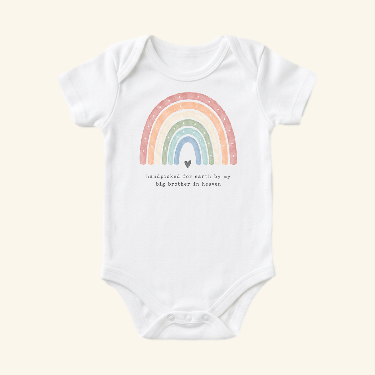 Toodleroos Rainbow Baby Onesie – Handpicked by My Big Brother in Heaven featuring a white baby bodysuit with a watercolor rainbow, a small heart, and the text, Handpicked for earth by my big brother in heaven.