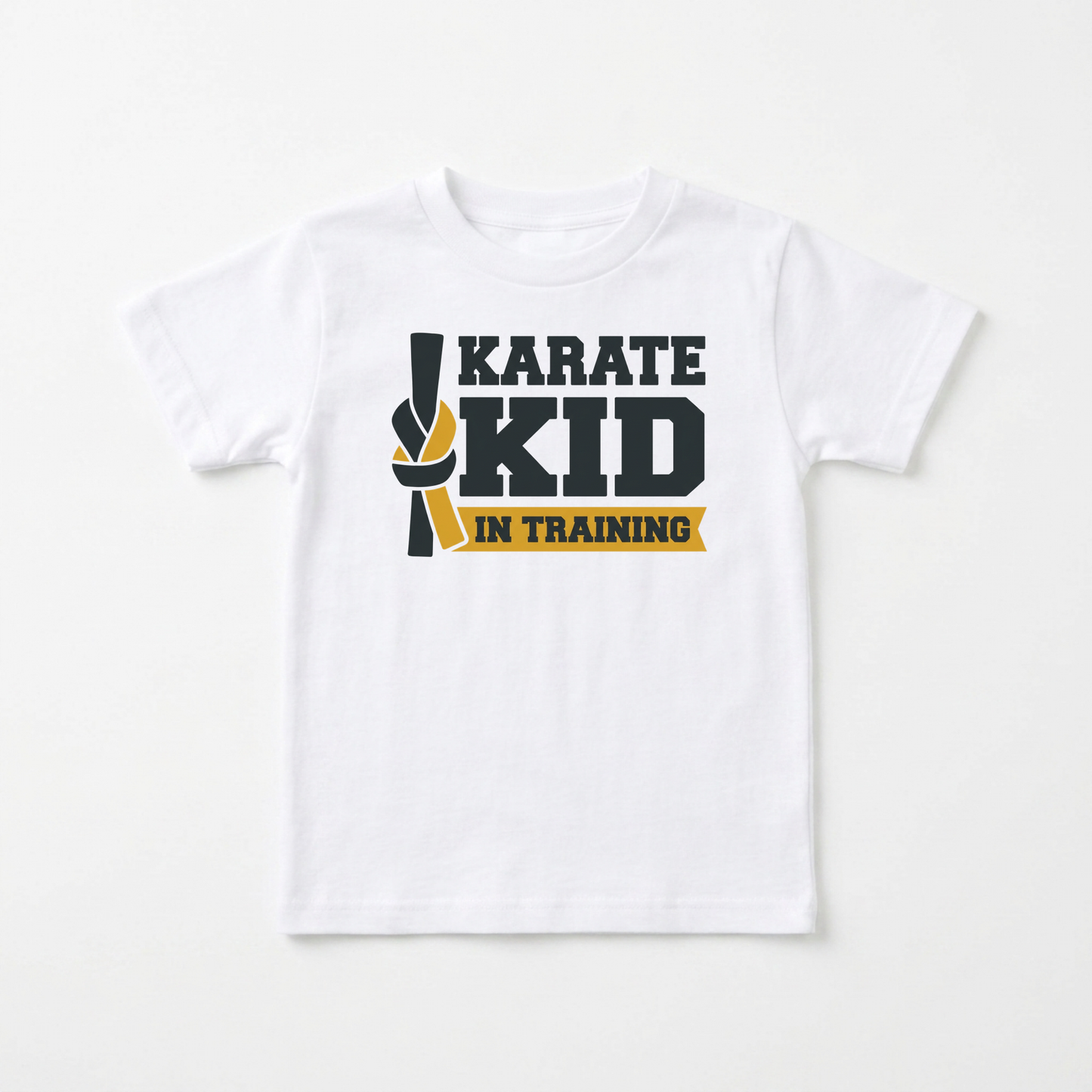 A white short-sleeve kids' t-shirt with a graphic on the chest that reads 'KARATE KID IN TRAINING' in dark gray and yellow, displayed against a clean white background.