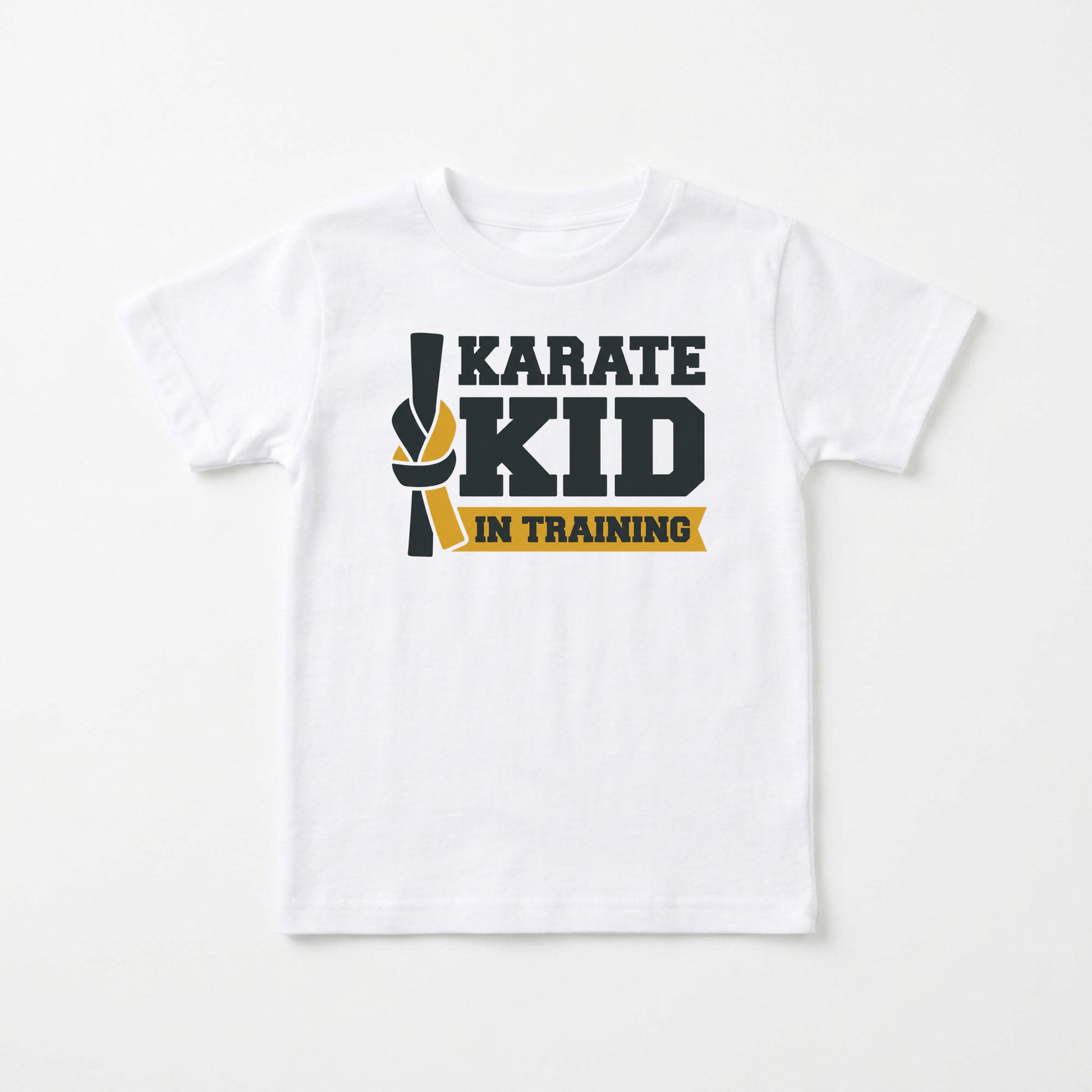 A white short-sleeve kids' t-shirt with a graphic on the chest that reads 'KARATE KID IN TRAINING' in dark gray and yellow, displayed against a clean white background.