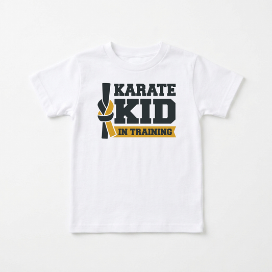 A white short-sleeve kids' t-shirt with a graphic on the chest that reads 'KARATE KID IN TRAINING' in dark gray and yellow, displayed against a clean white background.