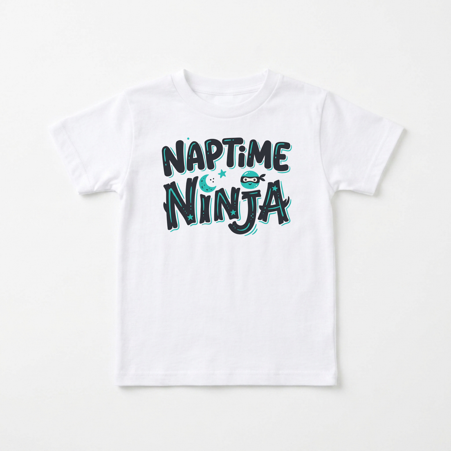 A white kids' short-sleeve t-shirt with a playful graphic reading 'NAPTIME NINJA' in dark teal and light blue bubble letters, featuring a small cartoon ninja character.
