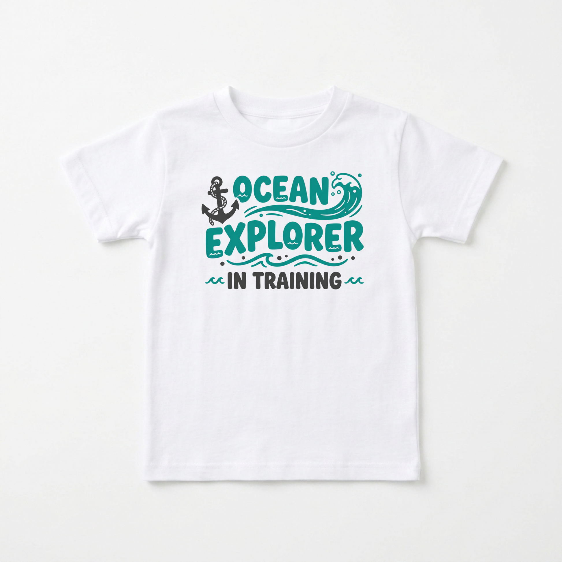 A white short-sleeve kids' t-shirt with a graphic on the chest that reads 'OCEAN EXPLORER IN TRAINING' in teal and black, featuring an anchor and wave illustration.