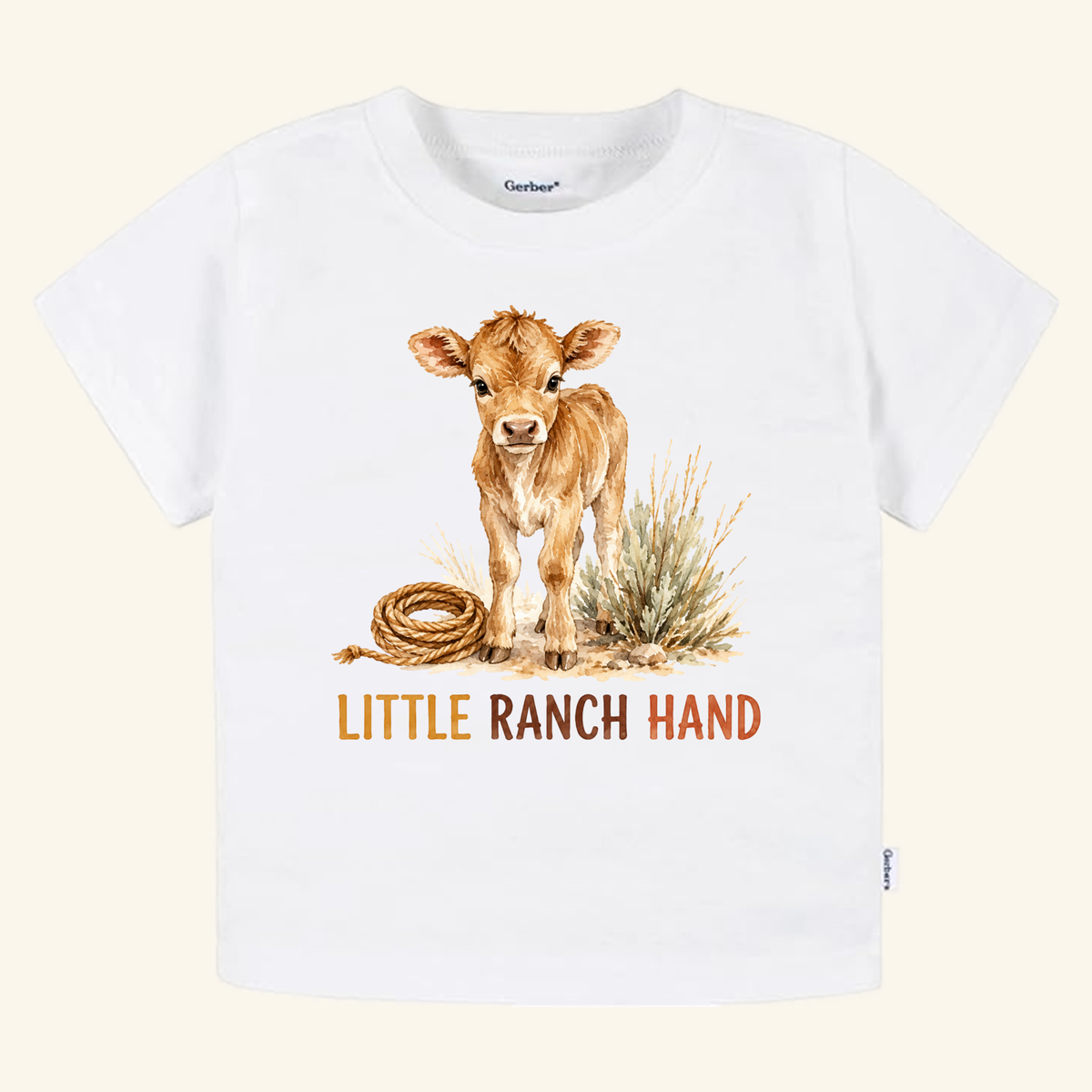 Little Ranch Hand Toddler Shirt featuring a white toddler t-shirt with a watercolor illustration of a calf, a coiled rope, and the text LITTLE RANCH HAND.