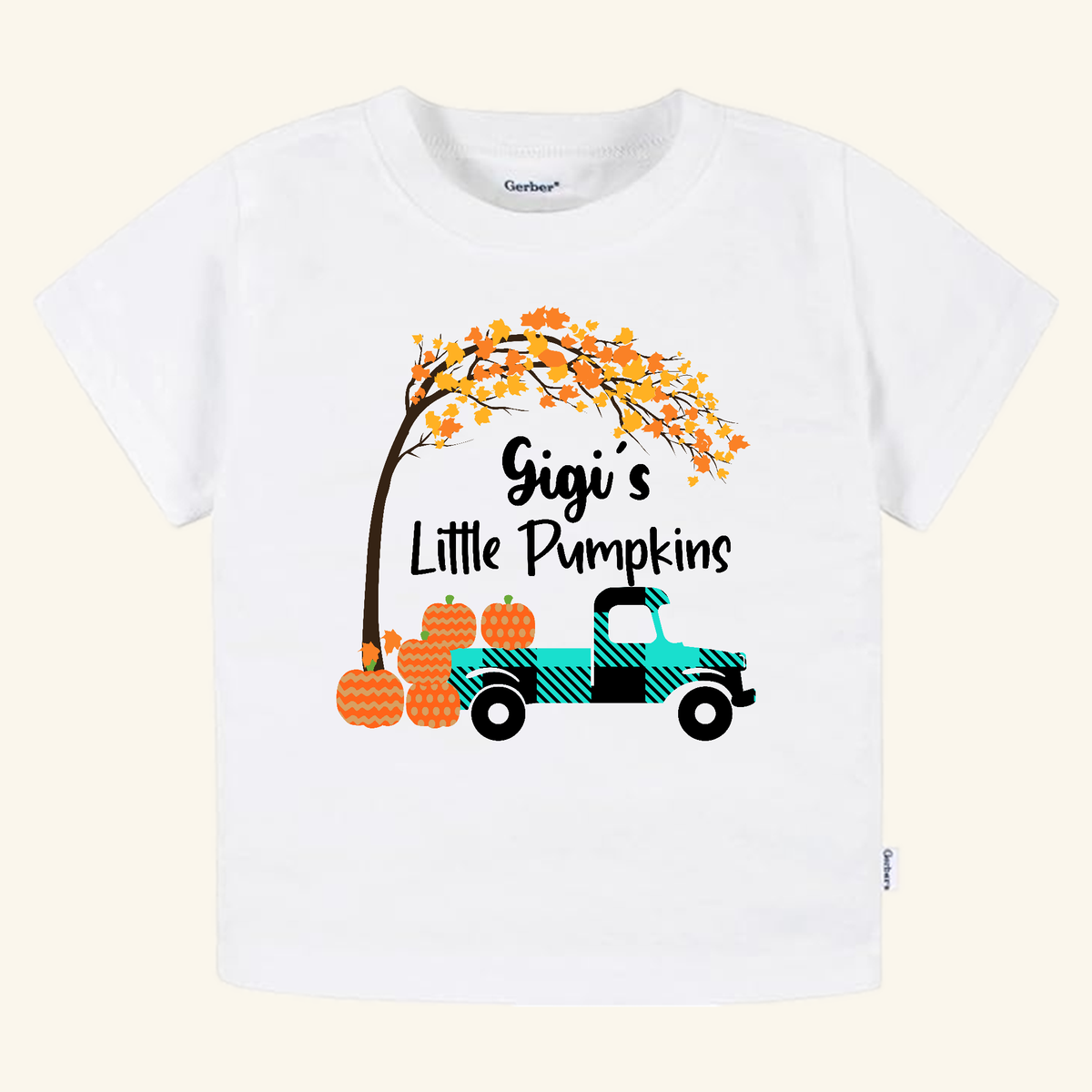 Gigi’s Little Pumpkins Toddler Shirt featuring a white t-shirt with a teal plaid truck, a tree with orange autumn leaves, and pumpkins.