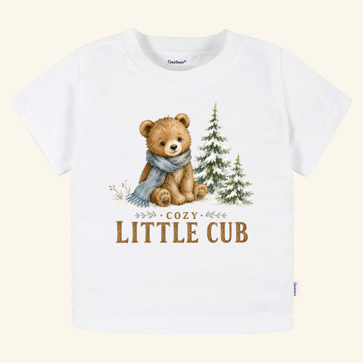 Cozy Little Cub Toddler Shirt – Cute Winter Bear Tee: a white cotton toddler tee featuring a watercolor illustration of a bear wearing a scarf next to pine trees, with the text COZY LITTLE CUB printed below.