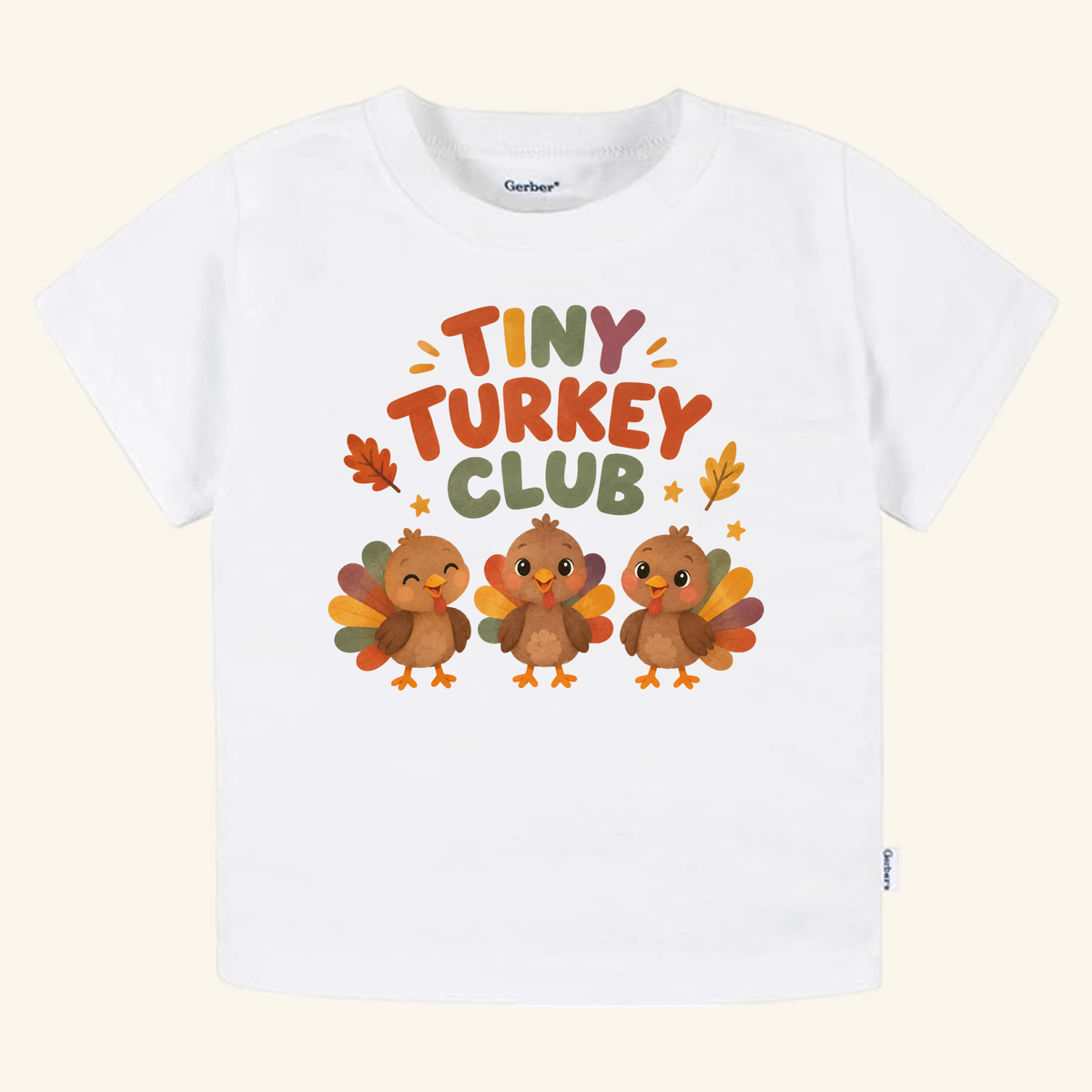 White short-sleeve Tiny Turkey Club Toddler Thanksgiving Shirt – Short-Sleeve Tee featuring an illustration of three cartoon turkeys and autumn leaves.