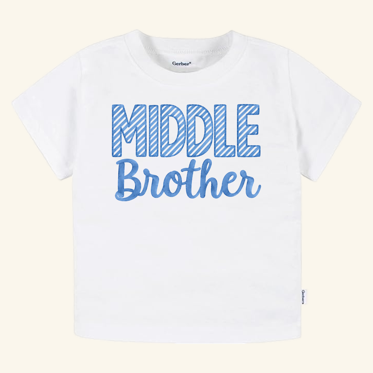 White Middle Brother Toddler Shirt – Blue Striped Letters Sibling Tee featuring a middle brother announcement with the words MIDDLE Brother printed in blue striped and solid letters.