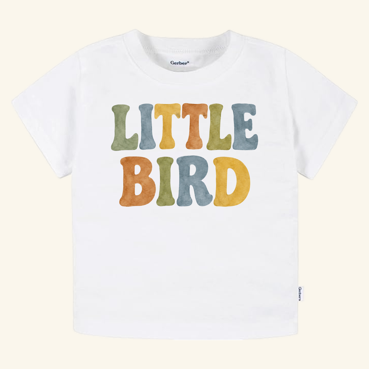 Little Bird Toddler Shirt – Retro Watercolor Lettering Tee featuring LITTLE BIRD in colorful, retro watercolor lettering on a white toddler t-shirt.