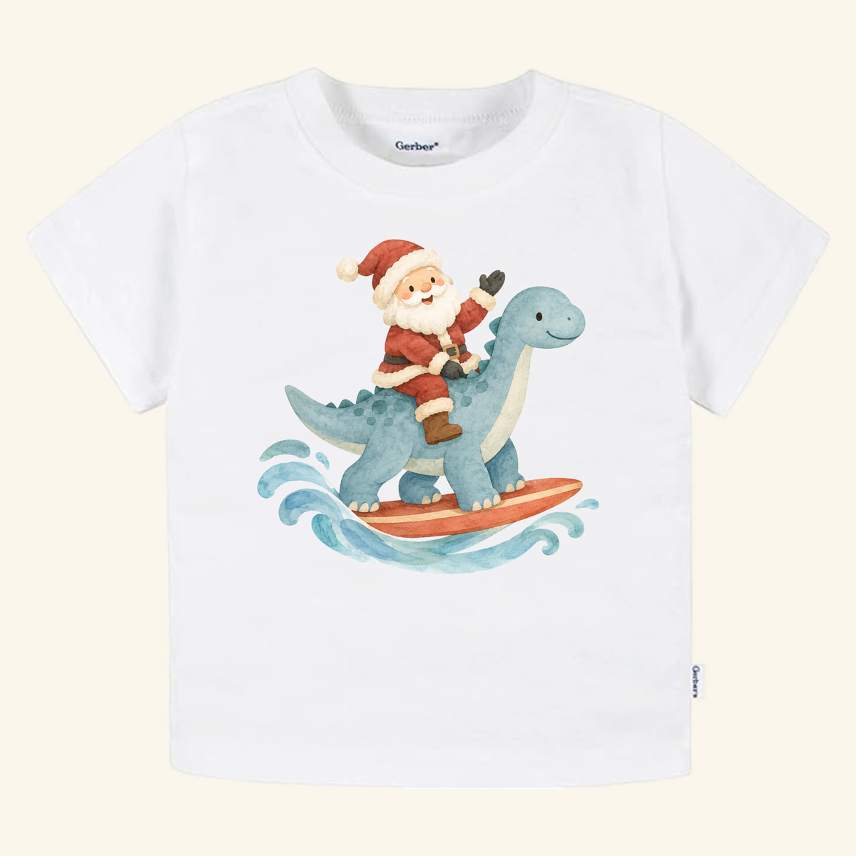 Toodleroos Santa Surfing Dinosaur Toddler Shirt featuring a white t-shirt with an illustration of Santa Claus riding a blue dinosaur on a surfboard for a festive Christmas beach look.
