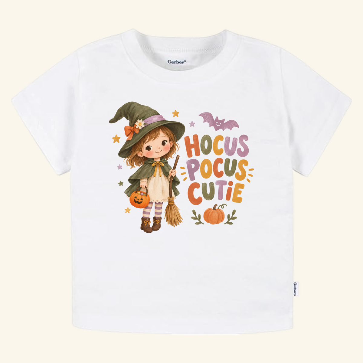 White Hocus Pocus Cutie Witch Toddler Halloween Shirt featuring an illustration of a young girl dressed as a witch holding a broom and pumpkin, with the colorful Hocus Pocus Cutie text.