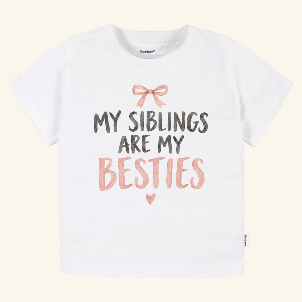 My Siblings Are My Besties Toddler Shirt – Pink Bow Sibling Tee featuring a pink bow graphic and My Siblings Are My Besties text in black and pink lettering above a small heart on a white toddler t-shirt.