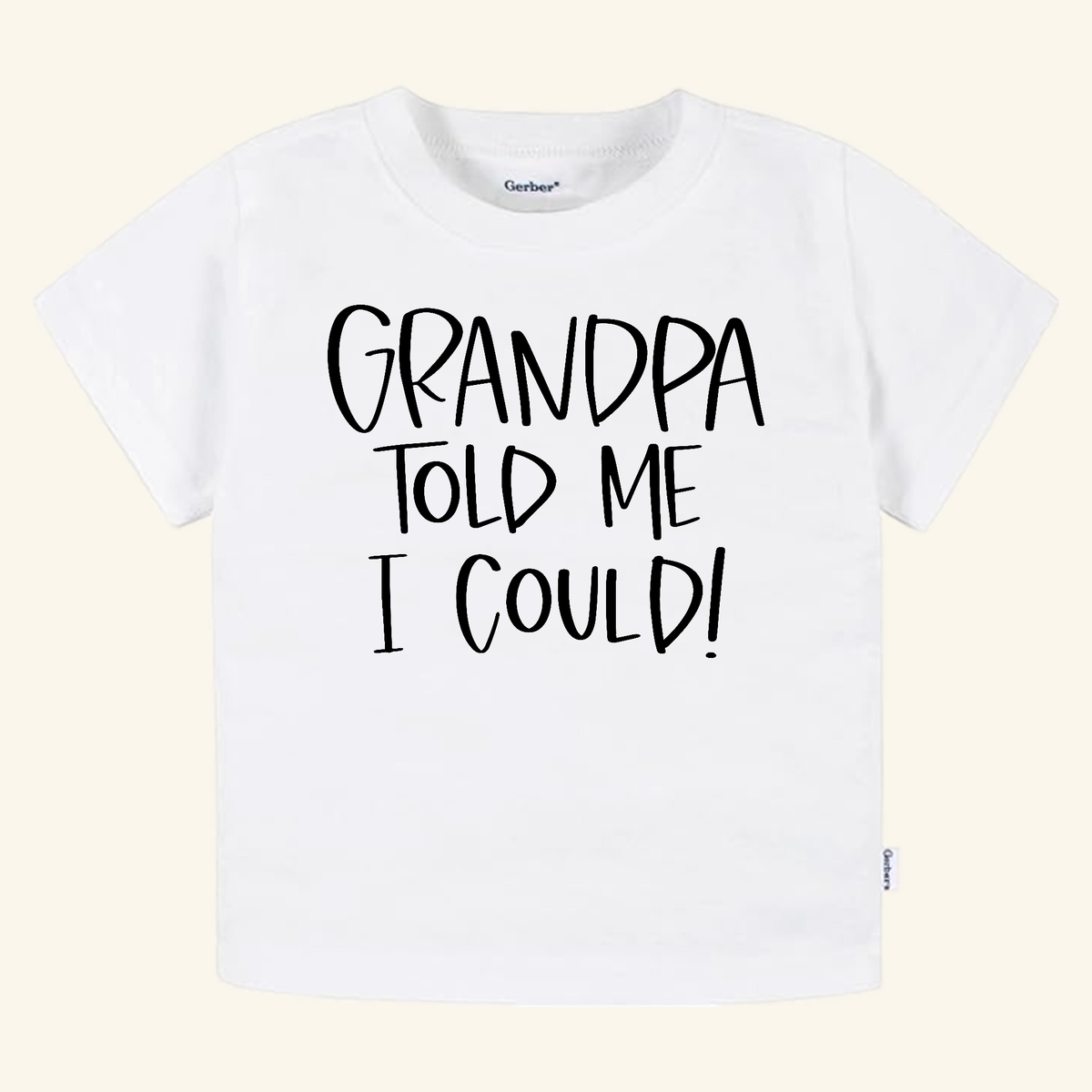 White toddler short-sleeve Funny Grandpa Toddler Shirt – Grandpa Told Me I Could Short-Sleeve Tee with the text GRANDPA TOLD ME I COULD! printed in black.