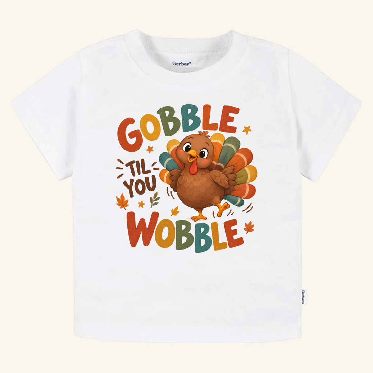 Gobble Til You Wobble Toddler Thanksgiving Shirt – Funny Turkey Tee featuring a white toddler t-shirt with a cartoon turkey and small autumn leaves.