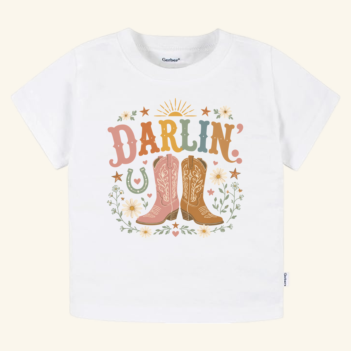 Toddler Cowgirl Shirt – Darlin’ Western Cowboy Boots Short-Sleeve Tee featuring a graphic of two cowboy boots, flowers, a horseshoe, and the word DARLIN in colorful, retro-style lettering.