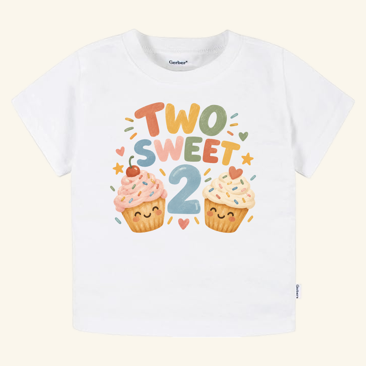 Toodleroos Two Sweet 2nd Birthday Toddler Shirt featuring a large blue number two, two smiling cupcakes, and colorful sprinkles, stars, and hearts.