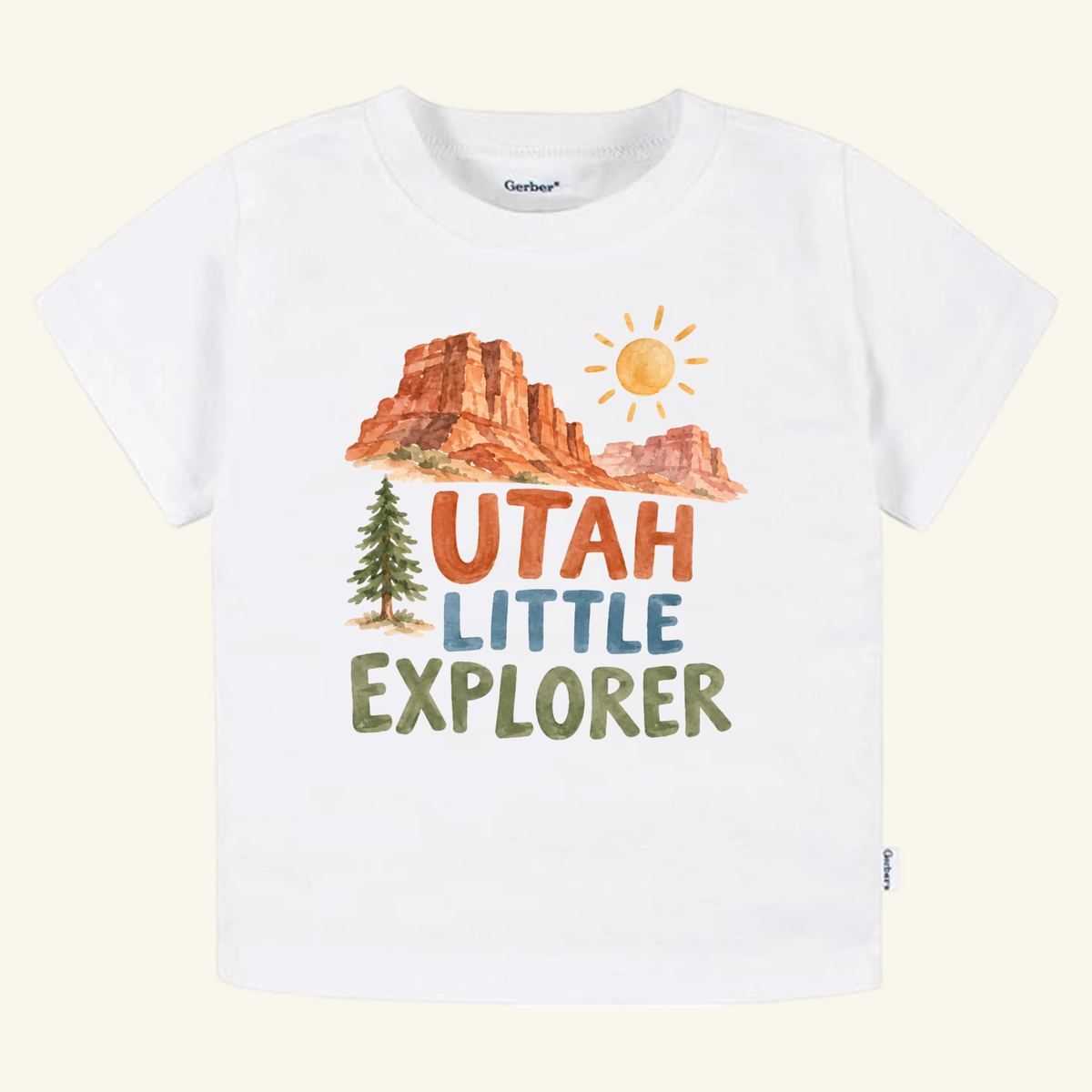 Utah Toddler Shirt – Little Explorer Red Rock Desert Tee featuring a white t-shirt with a watercolor graphic of red rock formations, a sun, and a pine tree with the text Utah Little Explorer.