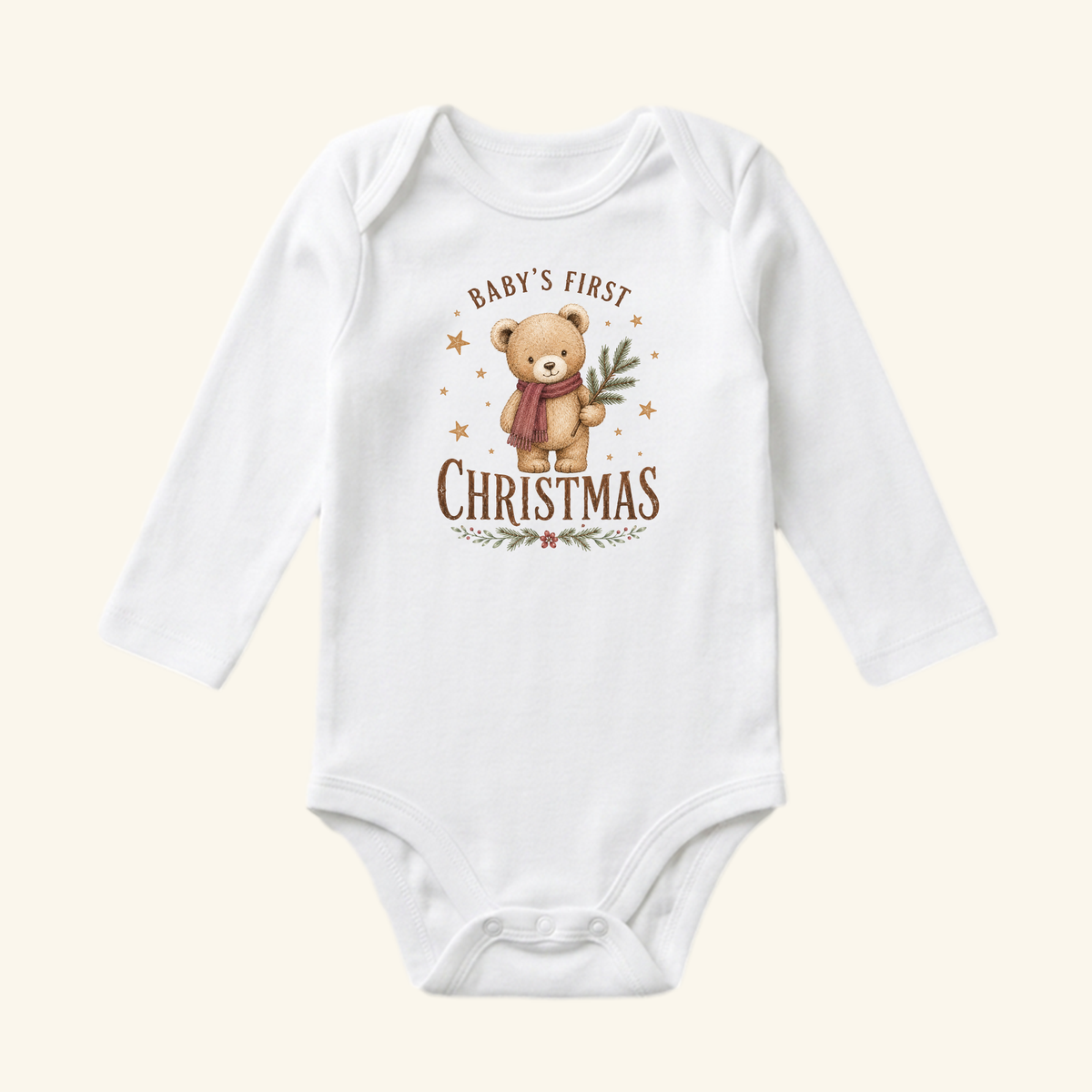 White long-sleeve Toodleroos Baby’s First Christmas Baby Onesie – Teddy Bear Christmas Bodysuit featuring a teddy bear wearing a scarf and holding a pine branch, with Babys First Christmas text above and below the illustration.