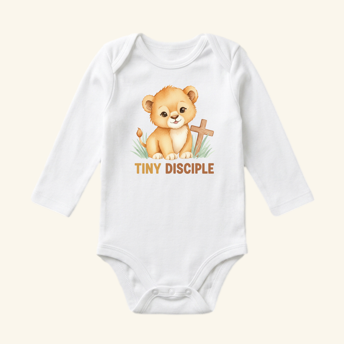 The Toodleroos Christian Baby Onesie – Tiny Disciple Lion Bodysuit features a cute lion cub, wooden cross, grass, and bold orange TINY DISCIPLE text—perfect for a unique Christian baby gift.