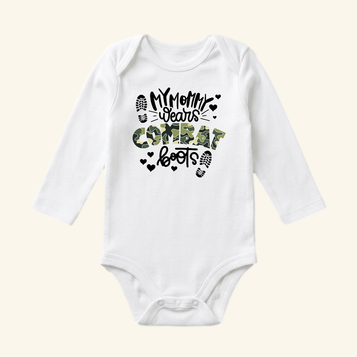 Toodleroos Military Baby Onesie – My Mommy Wears Combat Boots Bodysuit in white with black and camouflage lettering, accented by heart and boot print icons.