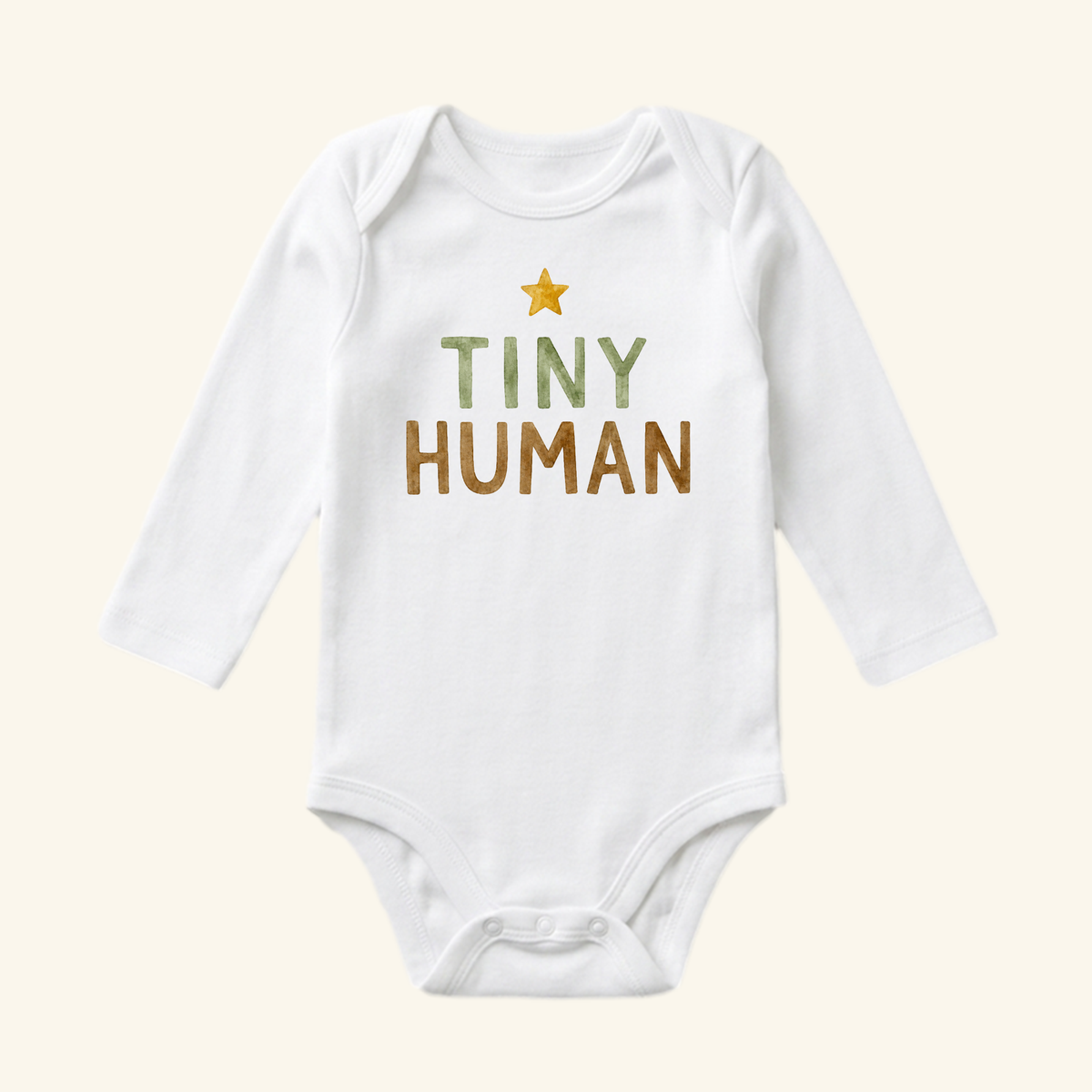 White long-sleeve Tiny Human Baby Onesie – Minimalist Star Bodysuit featuring a yellow star and the text TINY HUMAN printed on the chest.
