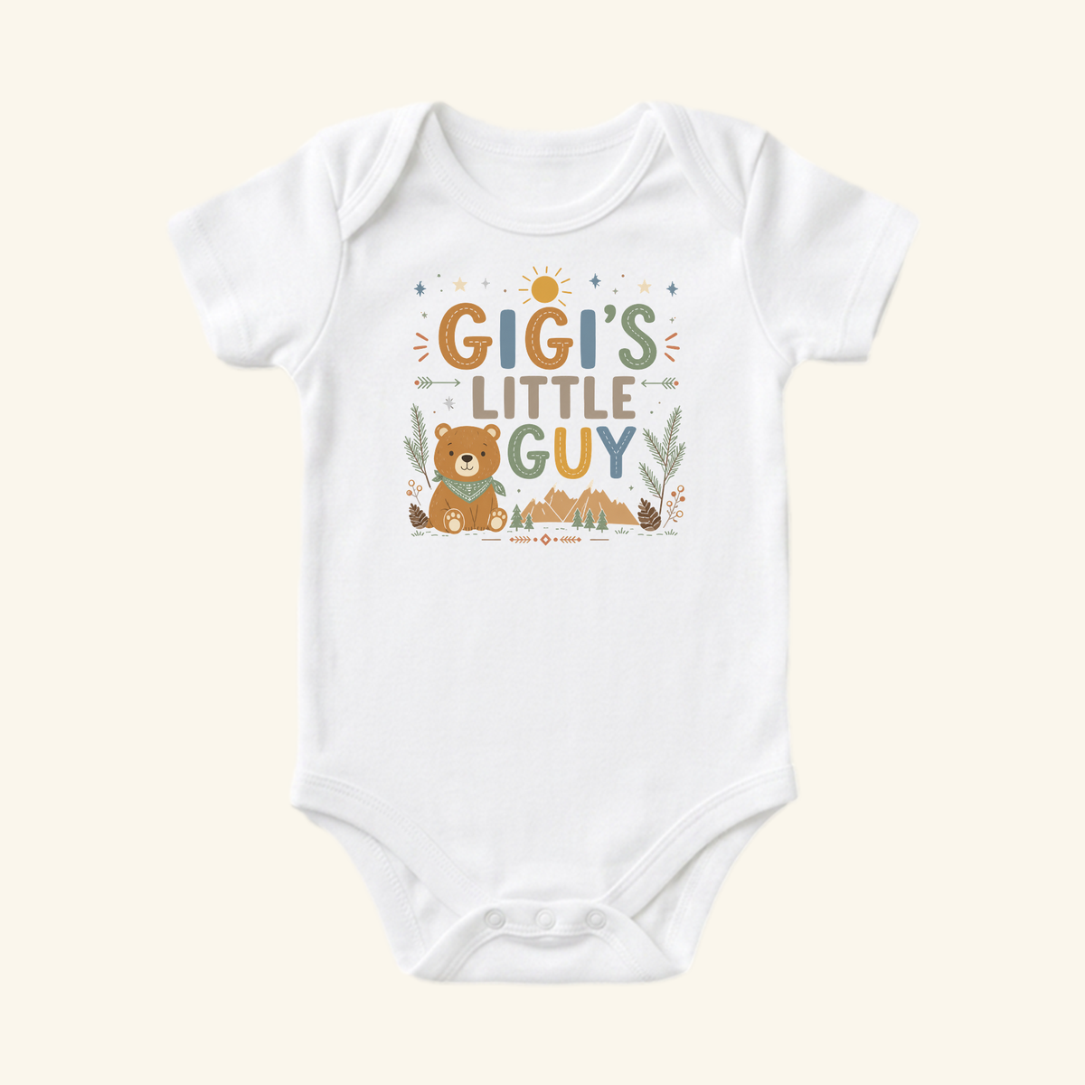 The Gigi’s Little Guy Baby Onesie – Woodland Bear Bodysuit by Toodleroos is a white, short-sleeved gift for grandsons, featuring a bear, sun, stars, trees, and mountains in earthy muted tones.