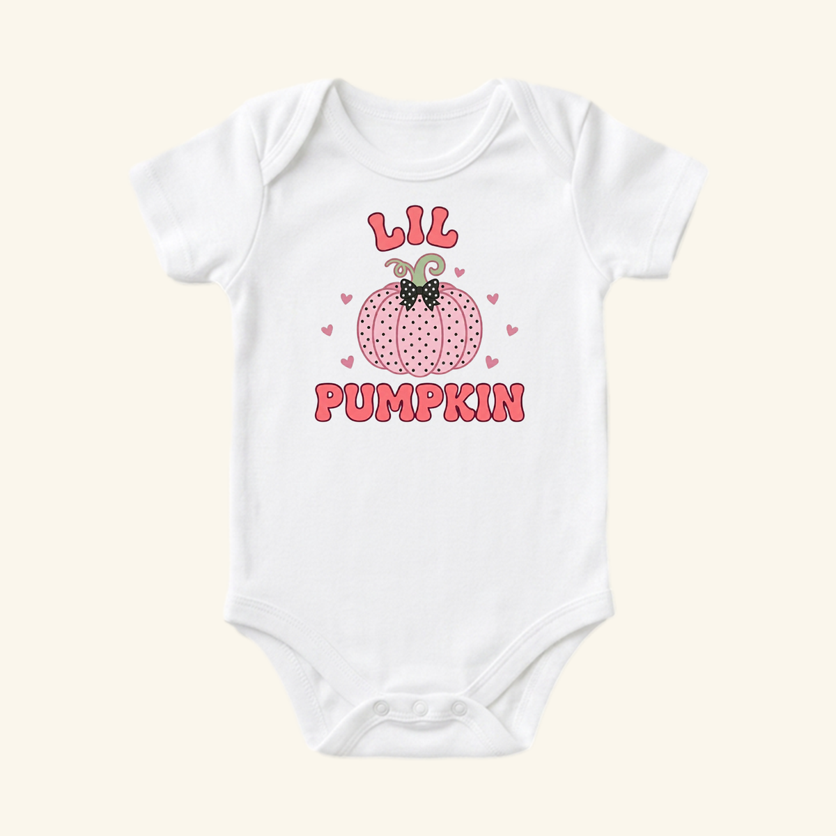 Toodleroos Lil Pumpkin Baby Girl Onesie – Fall Pumpkin Bodysuit: a white short-sleeve baby bodysuit featuring a pink dotted pumpkin, a black bow, and the text LIL PUMPKIN in pink letters.