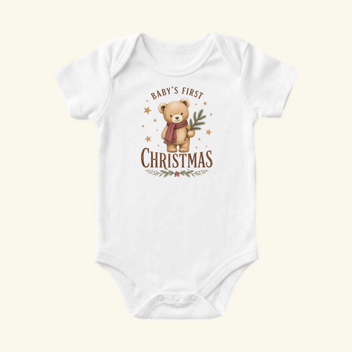 Toodleroos Baby’s First Christmas Baby Onesie – Teddy Bear Christmas Bodysuit, a white bodysuit featuring a teddy bear wearing a scarf and holding a pine branch, with the text Baby’s First Christmas and decorative stars.