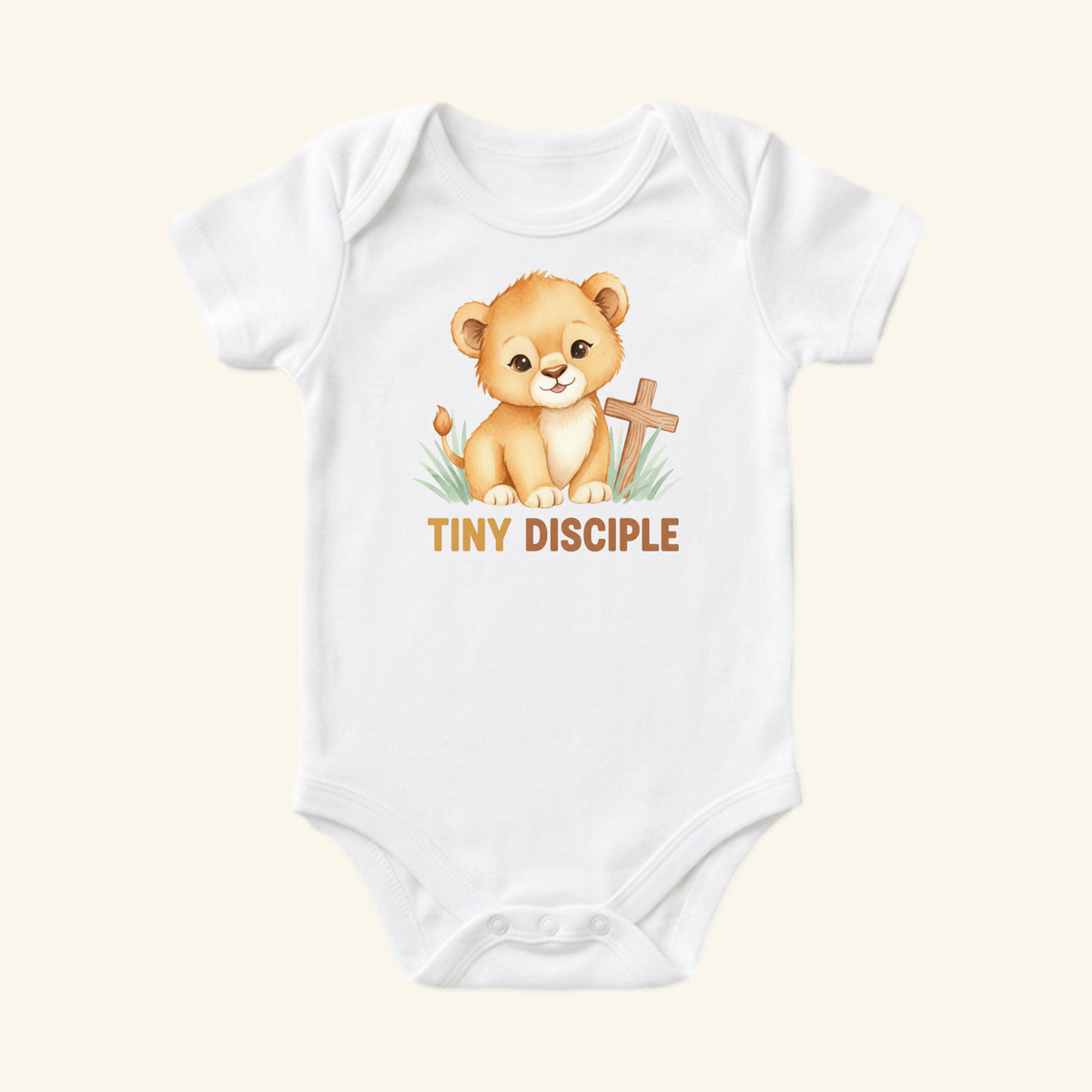 The Christian Baby Onesie – Tiny Disciple Lion Bodysuit by Toodleroos features a smiling lion cub by a cross, tulip, and grass—TINY DISCIPLE printed below. A sweet Christian gift for your baby!.