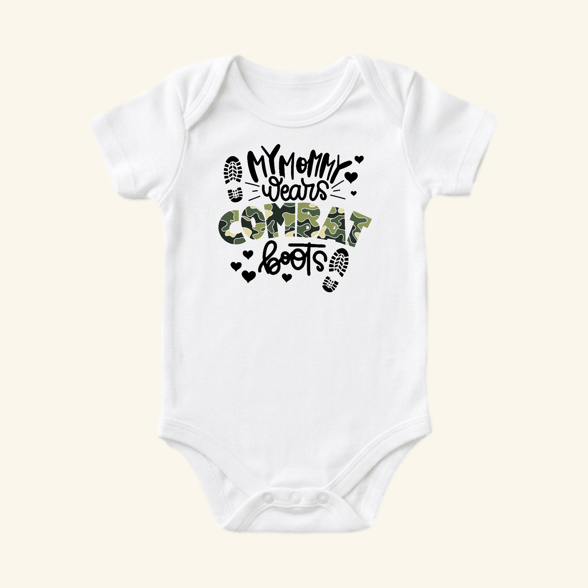Toodleroos Military Baby Onesie – My Mommy Wears Combat Boots, a white short-sleeved bodysuit with camouflage and black lettering, accented by heart and boot-print icons.