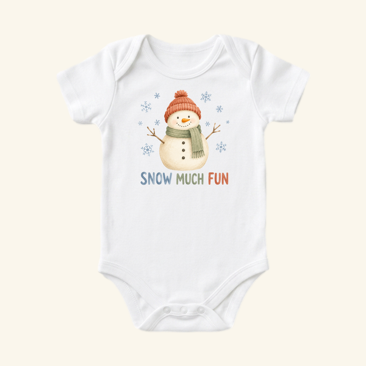 The Toodleroos Snowman Baby Onesie – Snow Much Fun Winter Bodysuit features a cheerful snowman with an orange hat and green scarf, colorful SNOW MUCH FUN text, and playful snowflakes—a cozy pick for winter.